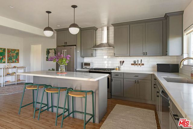a kitchen with cabinets table and chairs