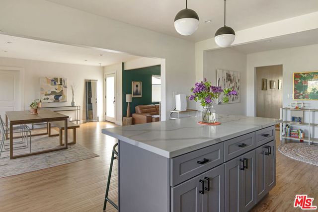 a view living room with kitchen island furniture and wooden floor