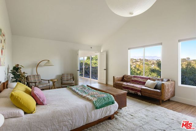 a bedroom with a bed and a couch