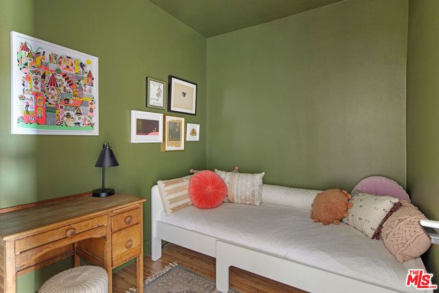 a bedroom with a bed and a potted plant