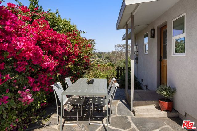 a view of a patio with table and chairs and potted plants