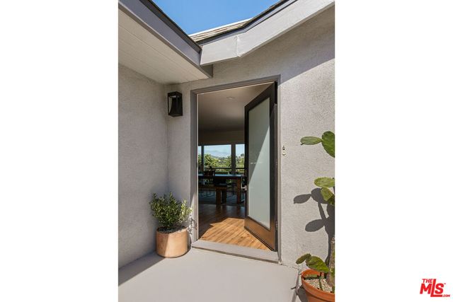 a hallway with painting on the wall
