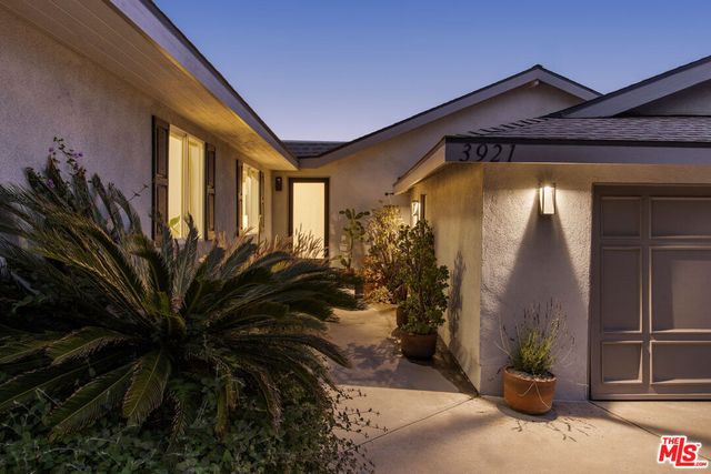 a backyard of a house with fire pit and outdoor seating