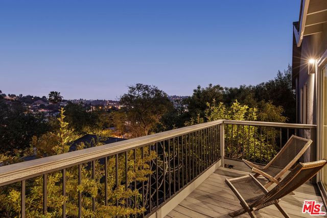 a view of a balcony with wooden floor and outdoor space