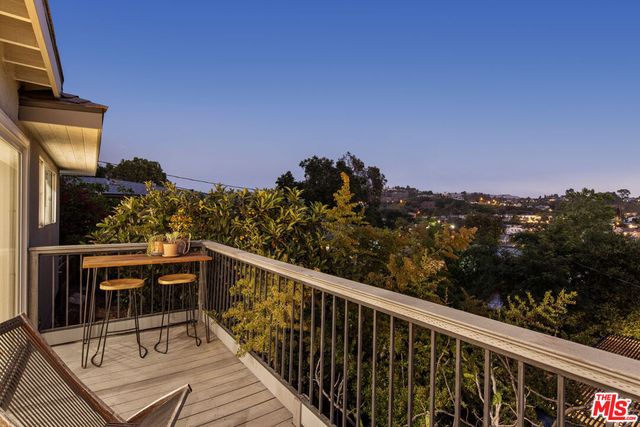 a view of backyard with a table and chairs and potted plants