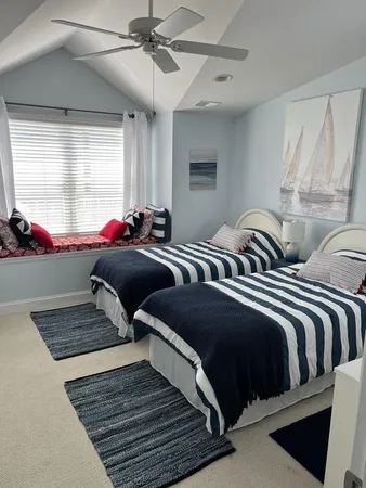 a bedroom with two beds and a chandelier