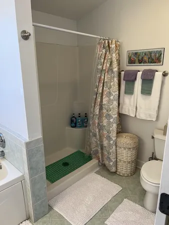 a bathroom with a toilet and a shower