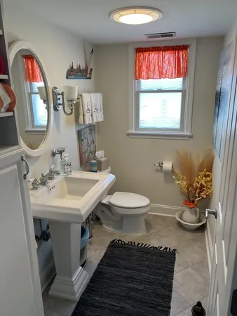 a bathroom with a toilet sink and mirror