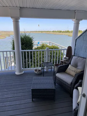 a roof deck with couch and chairs