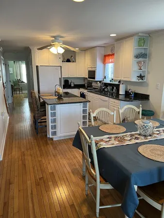 a kitchen with kitchen island granite countertop wooden floors and center island