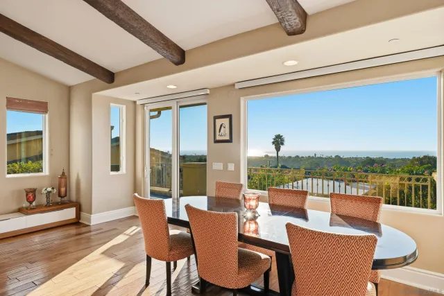 a dining room with furniture a garden and ocean view