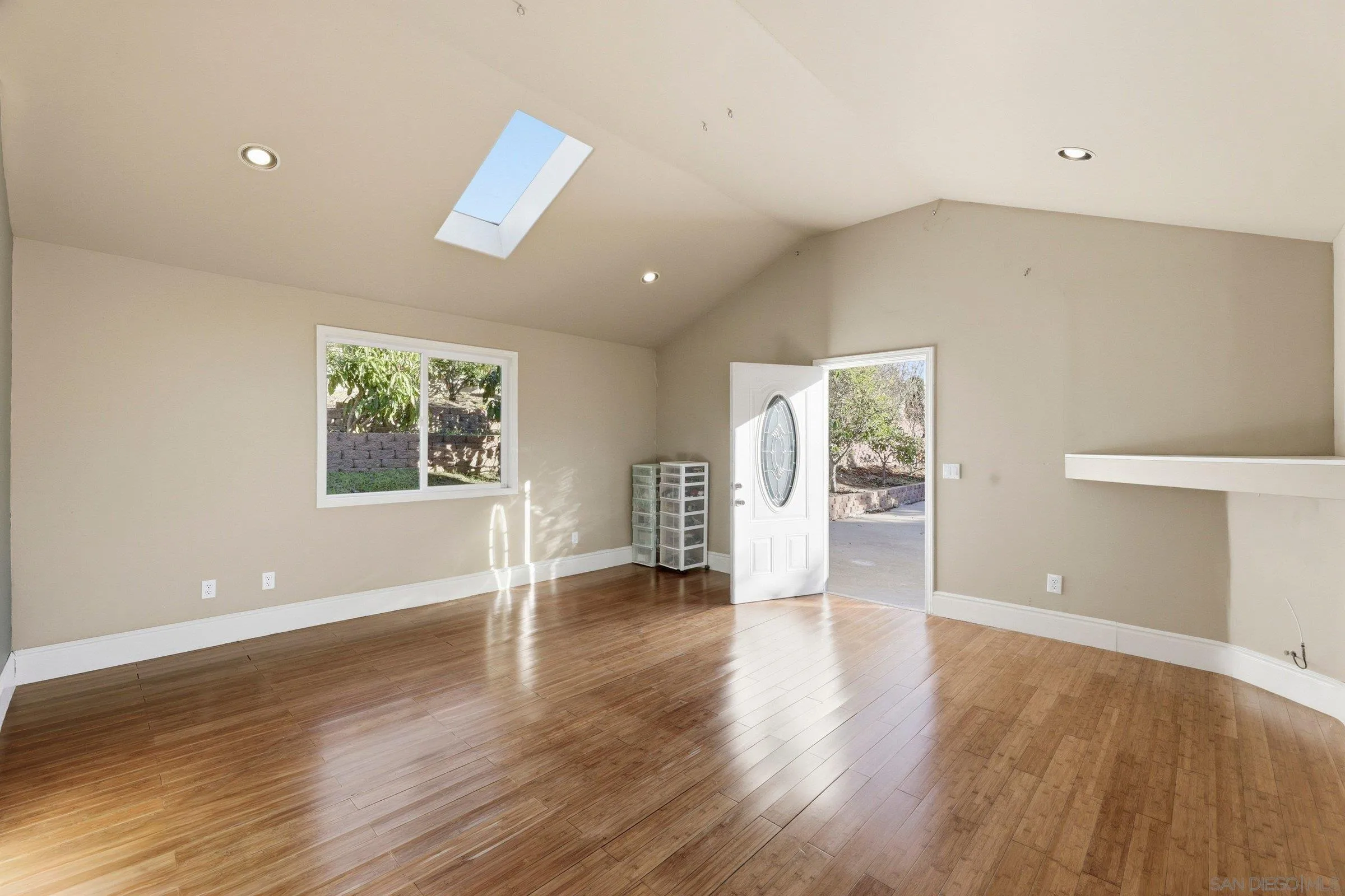 1690 Gascony Road Encinitas, CA 92024 - Photo 34 of 43 a view of an empty room with wooden floor and a window