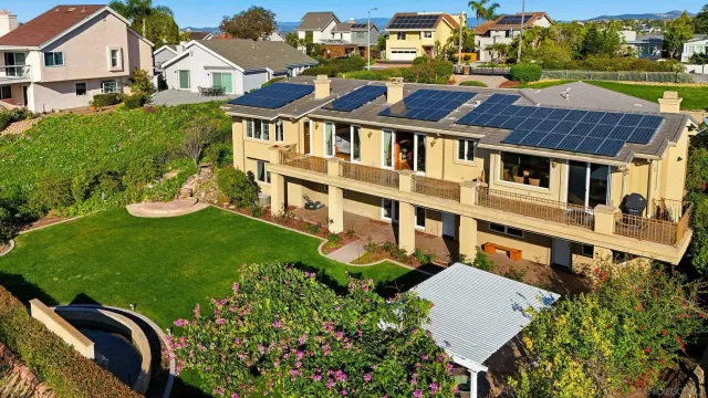 an aerial view of a house with garden space and street view