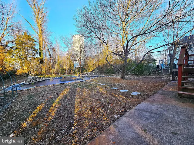 a view of a hallway with wooden floor and entryway