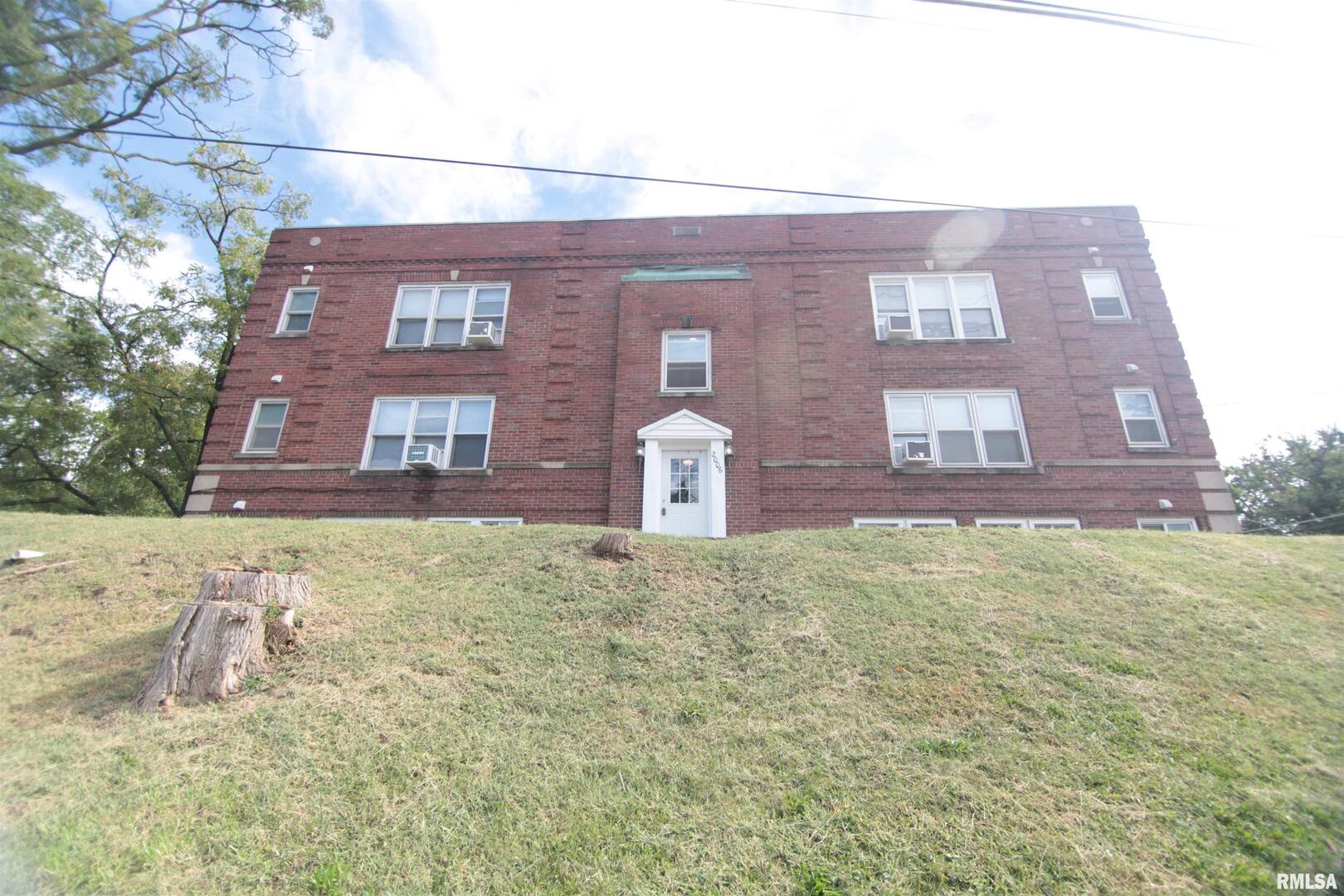 a view of a brick building next to a yard