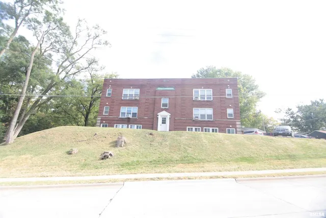 a view of a building with a yard