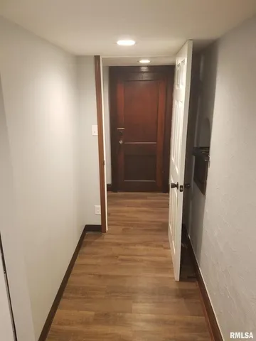 a view of hallway with wooden floor