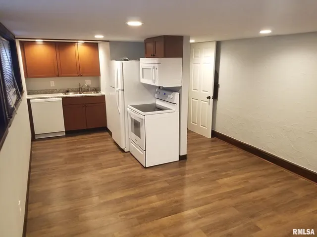 a view of a refrigerator in kitchen and wooden floor