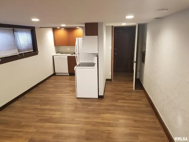 a kitchen with a refrigerator sink and cabinets