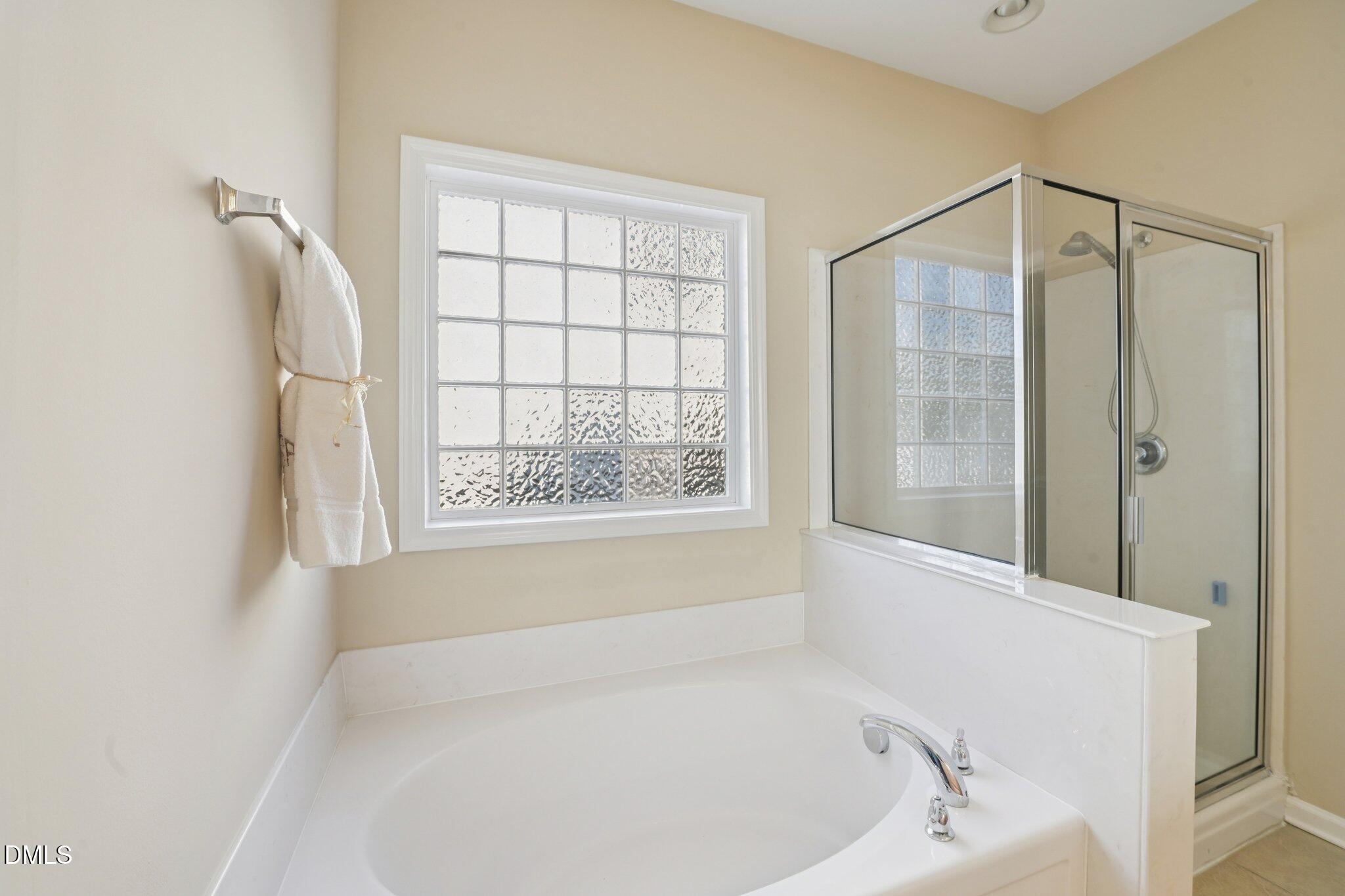 11 Hidden Ridge Court Durham, NC 27707 - Photo 19 of 30 a white bath tub sitting next to a window