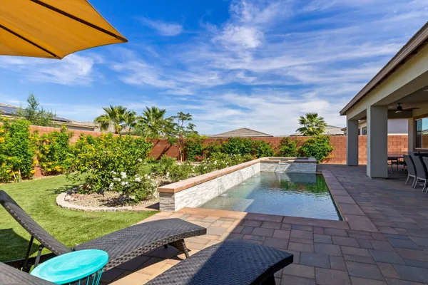 a view of a backyard with plants and outdoor seating