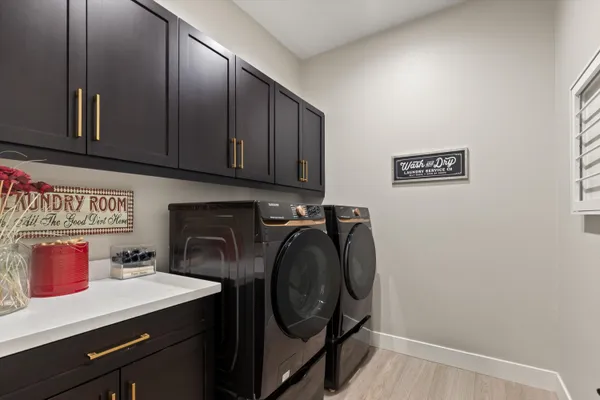 a utility room with sink dryer and washer