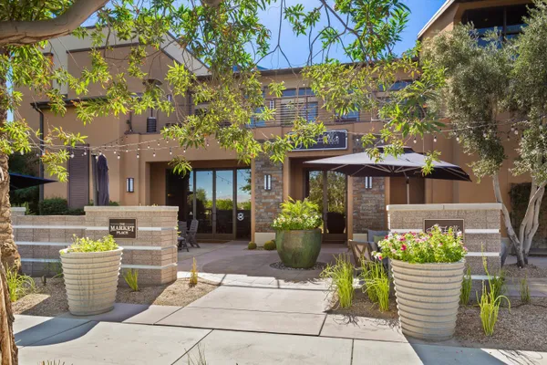 a front view of a building with potted plants