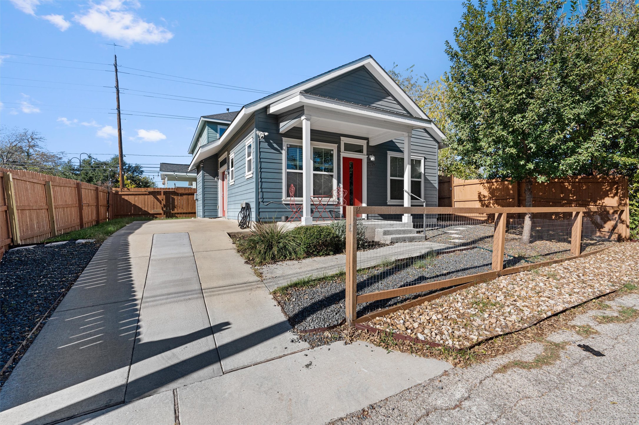 a view of a white house next to a yard