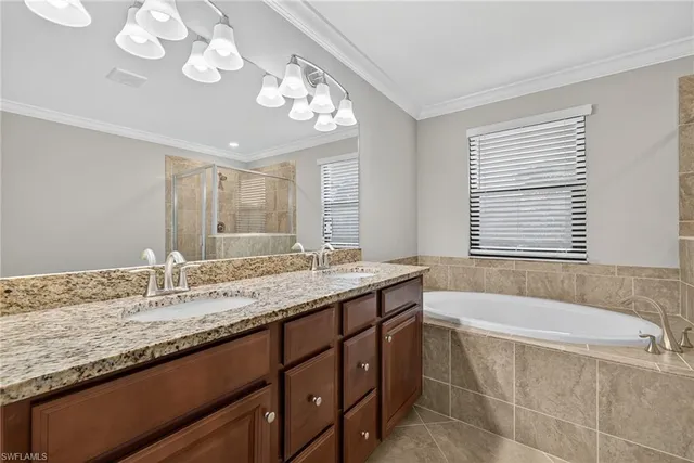 a spacious bathroom with a tub sink shower and mirror