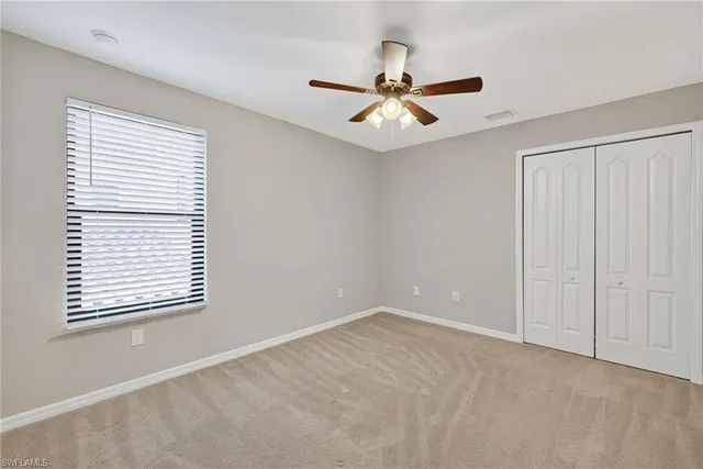 a bathroom with a granite countertop sink a toilet a mirror and bathtub