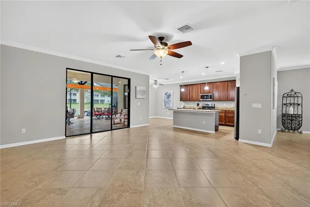 a view of a room with wooden floor and ceiling fan