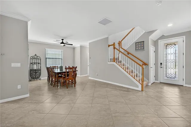 a view of a dining room with furniture and a chandelier fan
