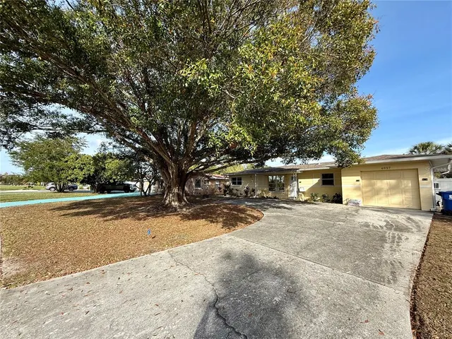 outdoor view of a house with a yard and garage