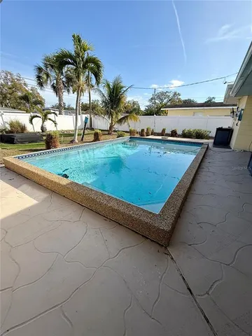 a view of swimming pool with a terrace and seating area