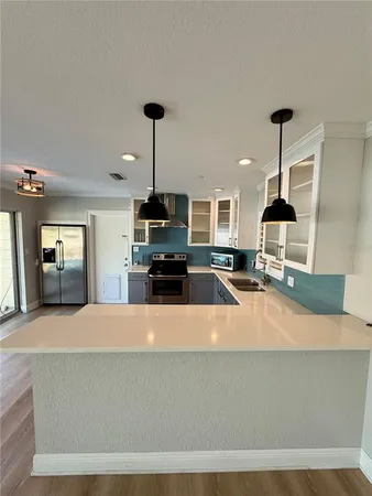 a kitchen with stainless steel appliances a sink stove and refrigerator