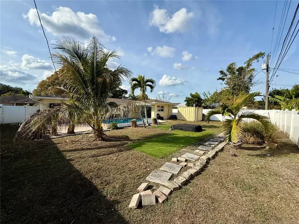 a view of a yard with cars park