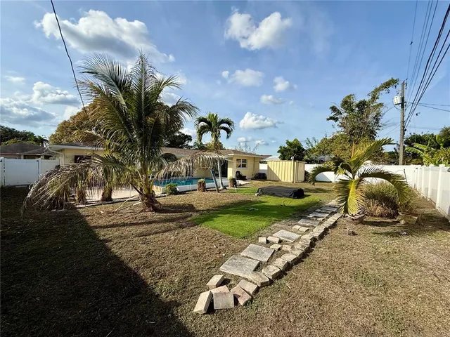 a view of a yard with cars park