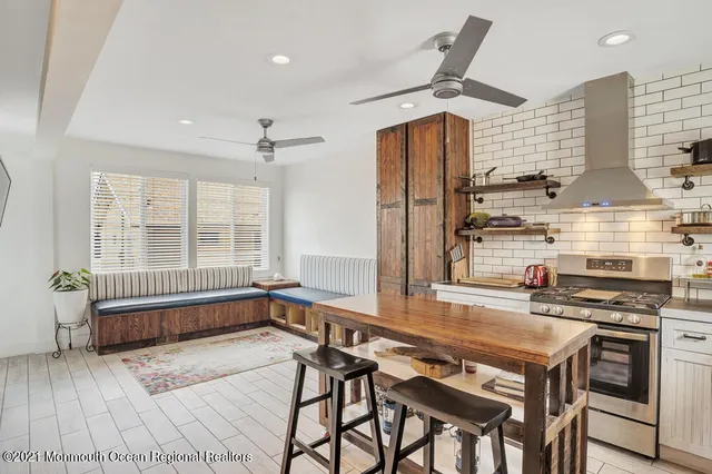 a kitchen with stainless steel appliances granite countertop a stove and a refrigerator
