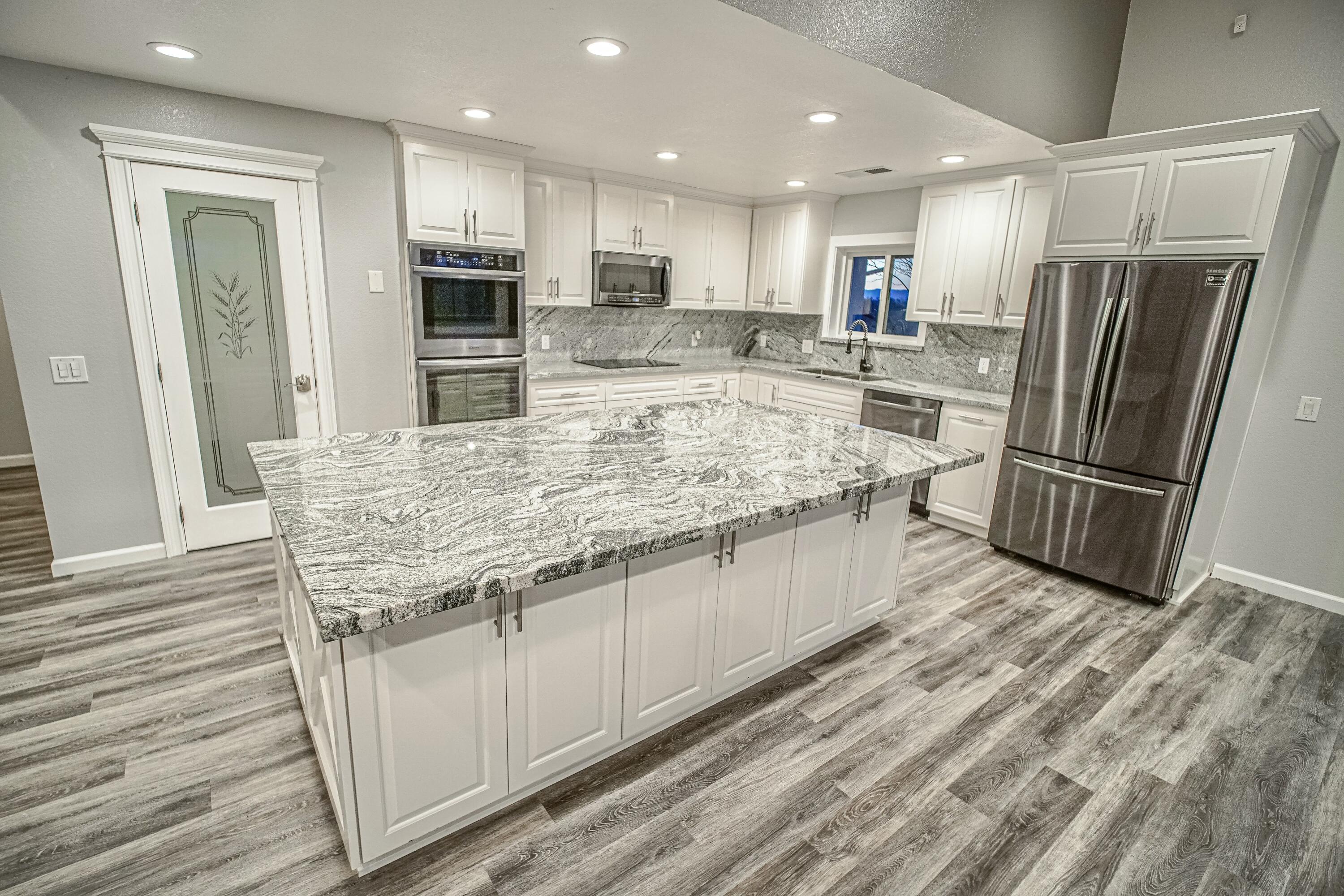 16785 Billy Lane Red Bluff, CA 96080 - Photo 12 of 69 a kitchen with stainless steel appliances granite countertop a refrigerator and a stove