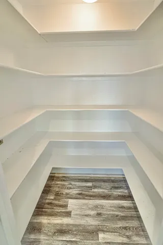 a spacious bathroom with a granite countertop sink a toilet a mirror and a window