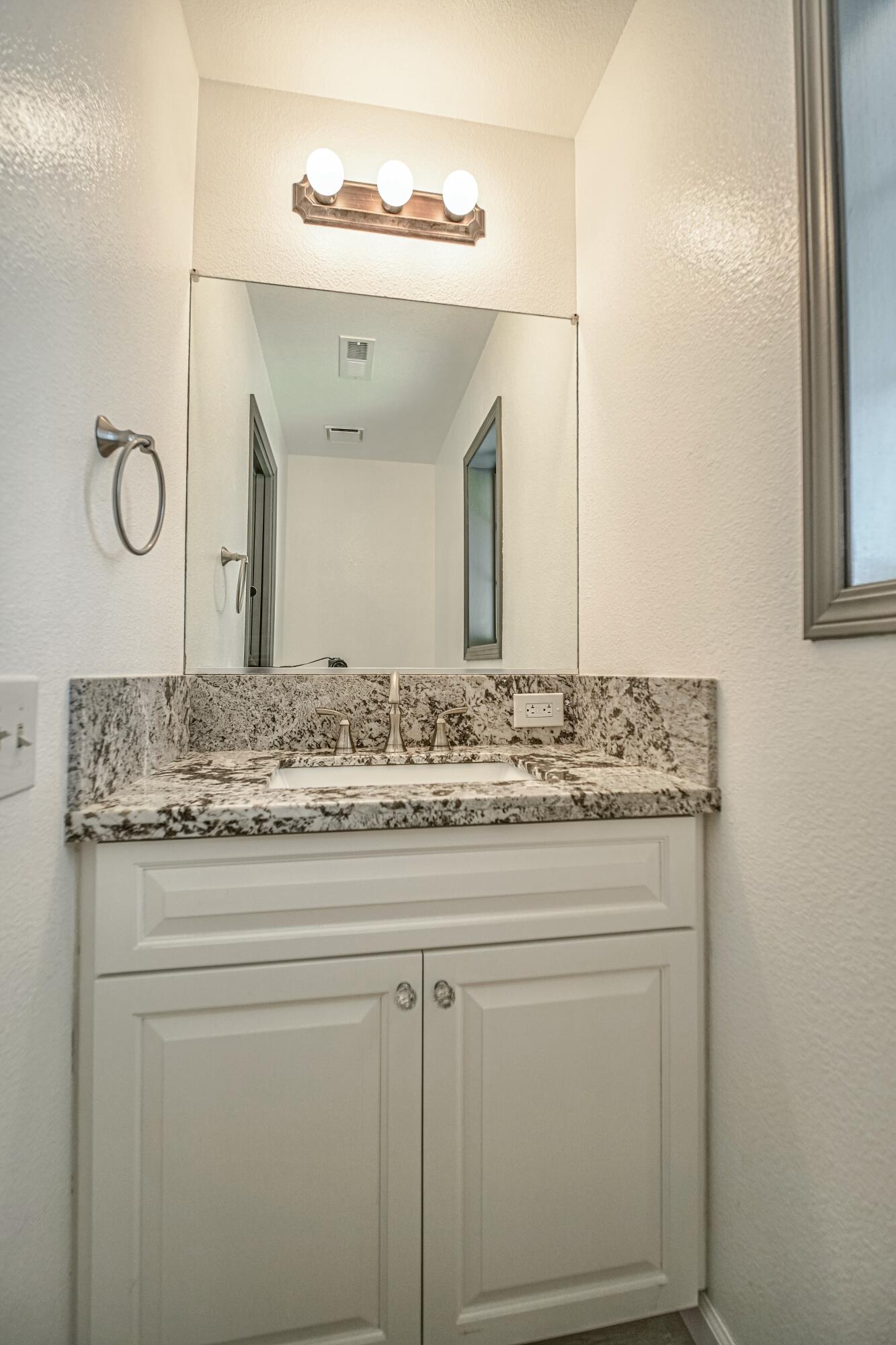 16785 Billy Lane Red Bluff, CA 96080 - Photo 22 of 69 a bathroom with a granite countertop sink and a mirror
