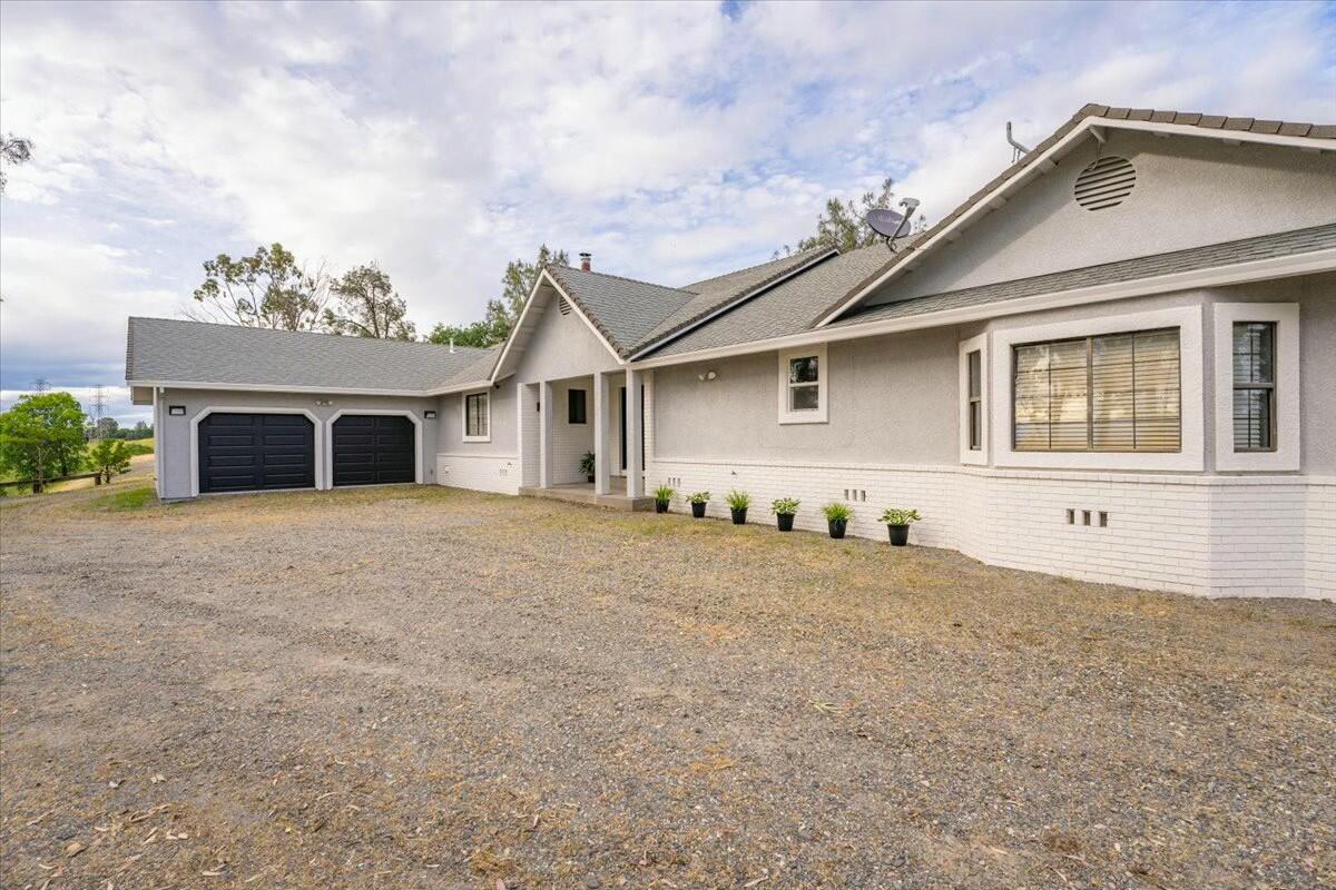 16785 Billy Lane Red Bluff, CA 96080 - Photo 41 of 69 a front view of a house with a yard and garage