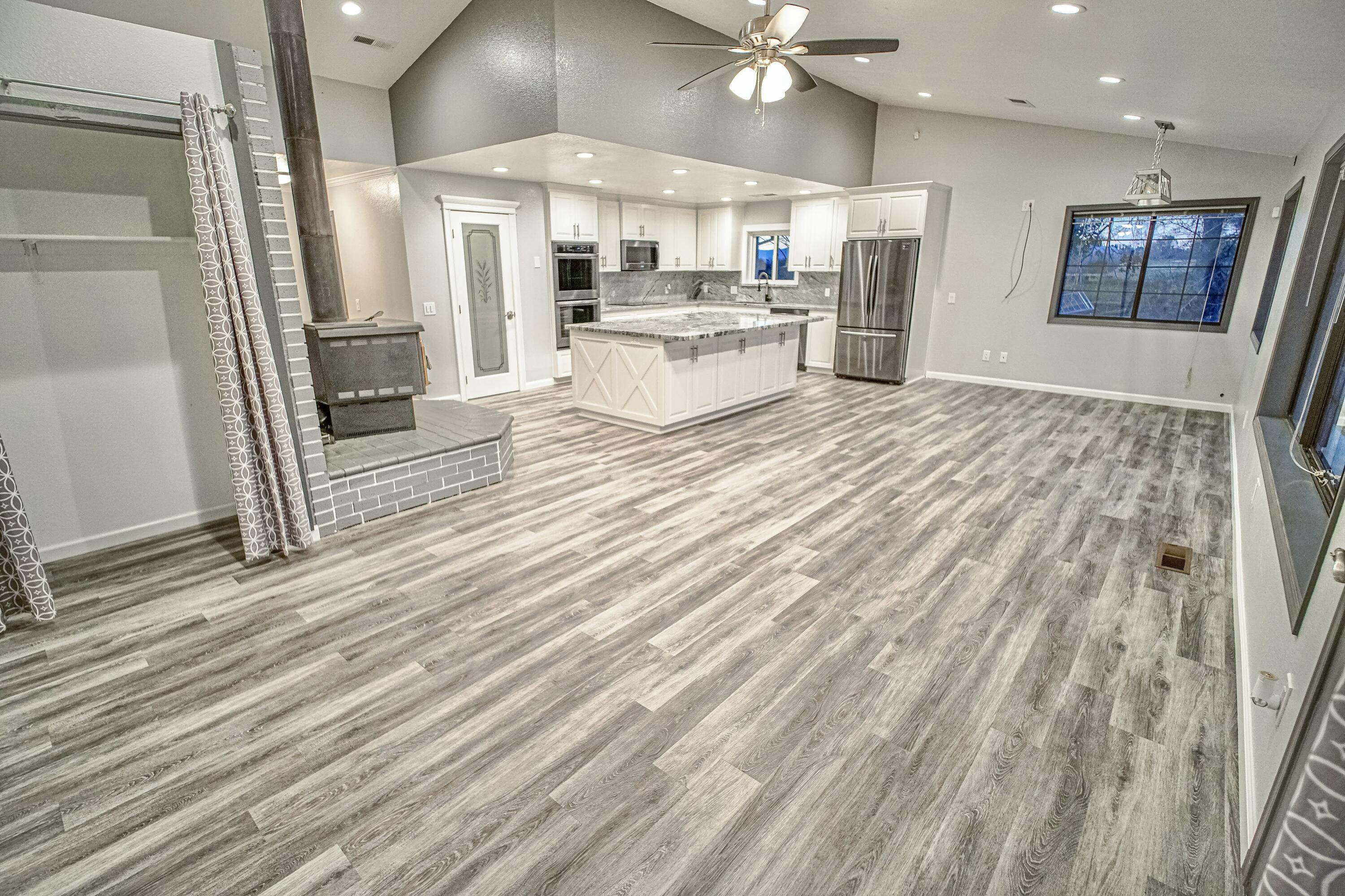 16785 Billy Lane Red Bluff, CA 96080 - Photo 8 of 69 a view of a living room and kitchen with stainless steel appliances wooden floor