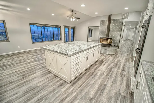 a kitchen with stainless steel appliances granite countertop a stove a sink and a refrigerator