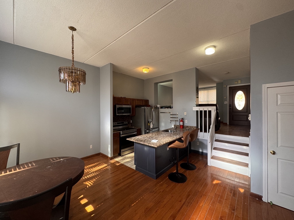 100 Lawn Street, Unit 100 Boston, MA 02120 - Photo 1 of 40 a bedroom with furniture and a wooden floor