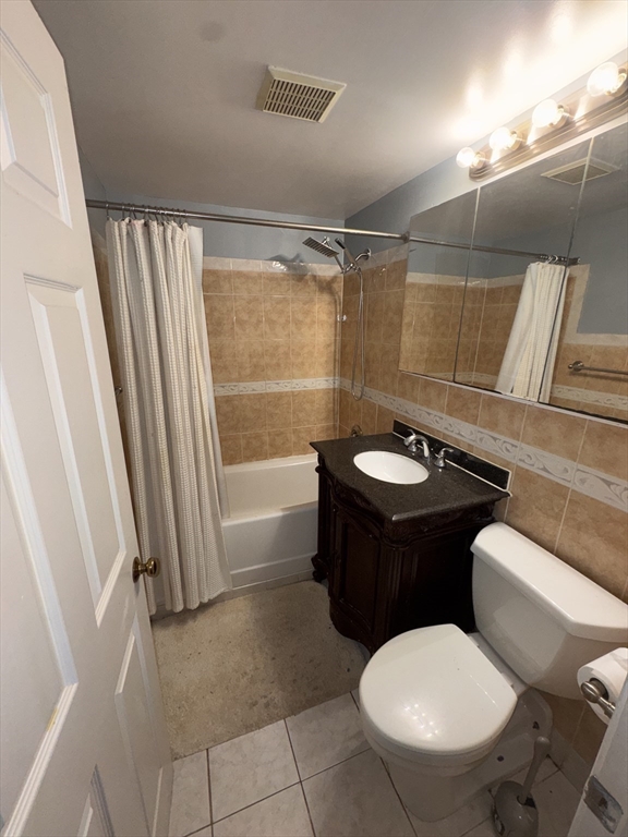 100 Lawn Street, Unit 100 Boston, MA 02120 - Photo 16 of 40 a bathroom with a sink a toilet a mirror and bathtub