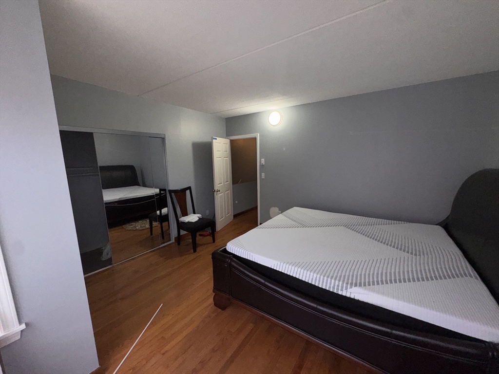 100 Lawn Street, Unit 100 Boston, MA 02120 - Photo 20 of 40 a bed room with a bed and a chair