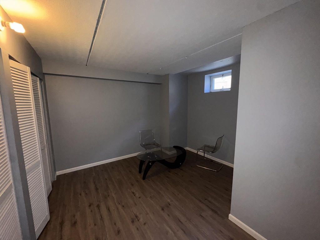 100 Lawn Street, Unit 100 Boston, MA 02120 - Photo 23 of 40 a room that has a bed and a window