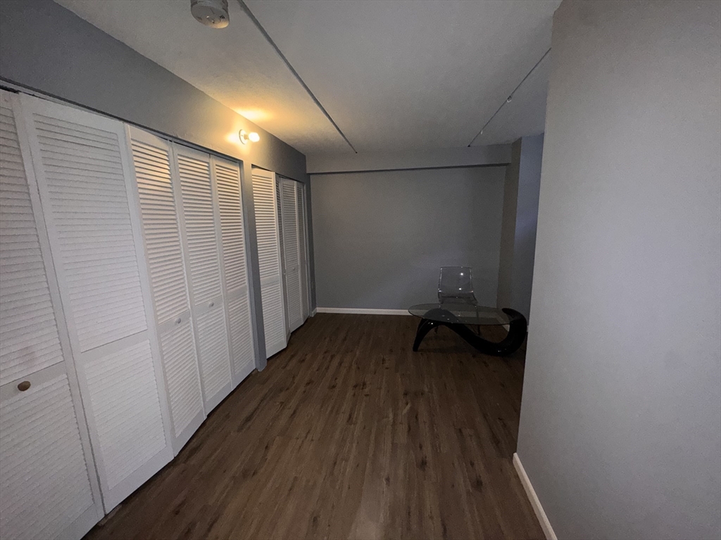 100 Lawn Street, Unit 100 Boston, MA 02120 - Photo 24 of 40 a room view with wooden floor and bench