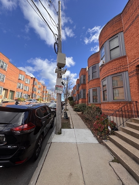 100 Lawn Street, Unit 100 Boston, MA 02120 - Photo 29 of 40 a view of a car park in front of a building